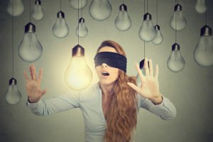 blind folded woman with light bulbs