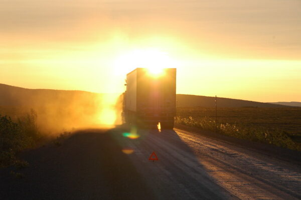 truck driving into the sun 