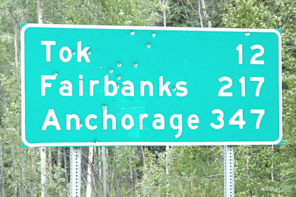 Alaska Road Sign Green with bullet holes 
