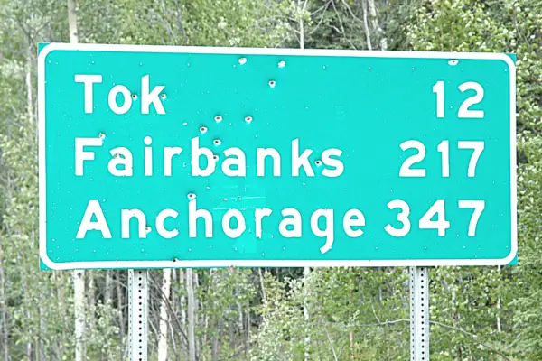 Alaska Road Sign Green with bullet holes 