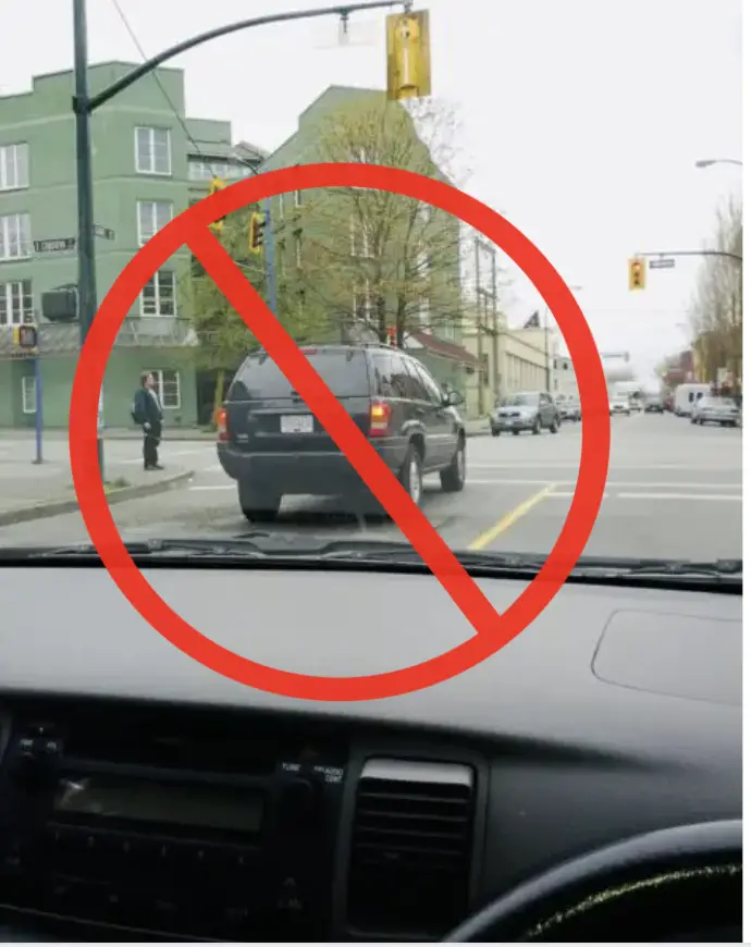 car stopped on the wrong side of the yellow road lines 